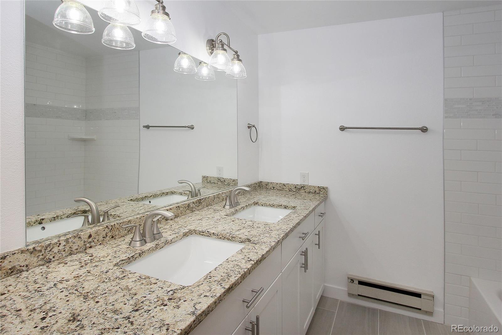 6250 Waterfall Loop Manitou Springs, CO 80829 - Photo 25 of 36 a bathroom with a granite countertop sink and a mirror