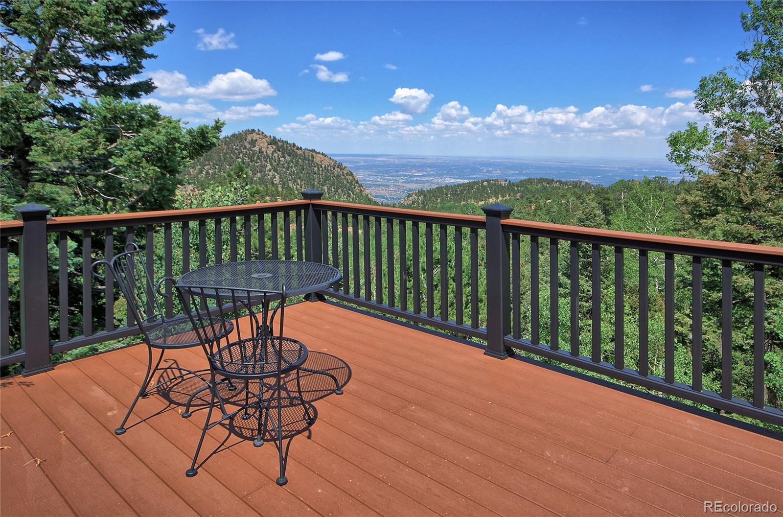 6250 Waterfall Loop Manitou Springs, CO 80829 - Photo 27 of 36 a view of a balcony with wooden floor and outdoor seating