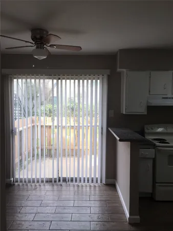 a kitchen with a sink a refrigerator and cabinets