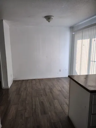 a view of a room with wooden floor and windows