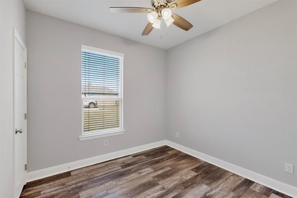 634 Gant Road Sherman, TX 75090 - Photo 25 of 40 Room featuring wood-finish flooring, light gray walls, and white trim