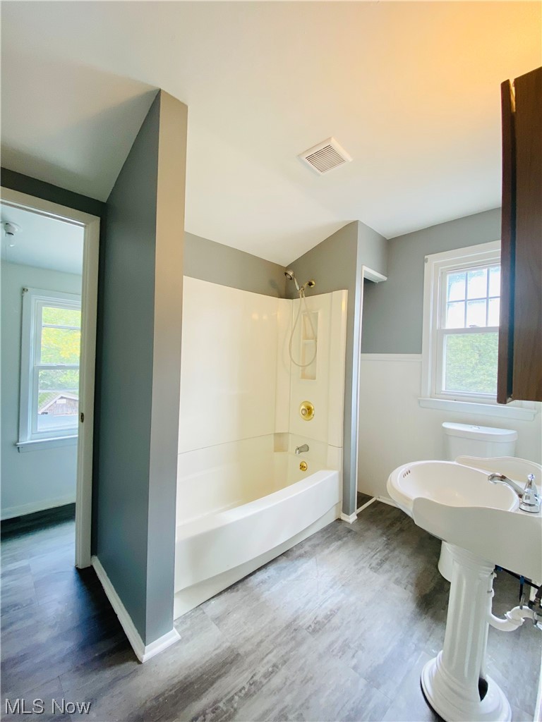 3683 Highland Road Cleveland, OH 44111 - Photo 15 of 17 Full bathroom featuring sink, a wealth of natural light, bathing tub / shower combination, and wood-type flooring