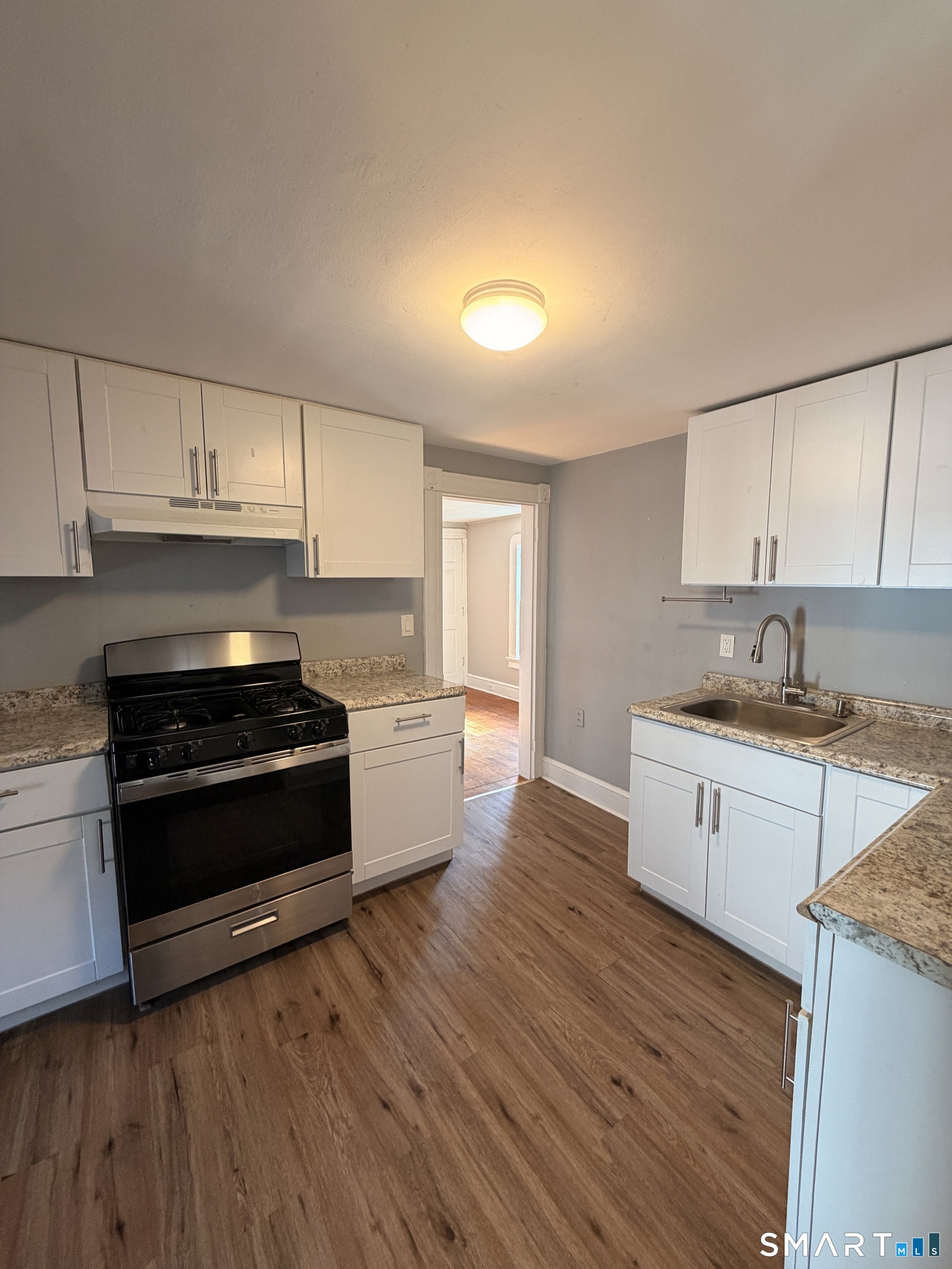 30 Sunset Avenue Waterbury, CT 06708 - Photo 2 of 9 a kitchen with granite countertop a stove and a sink