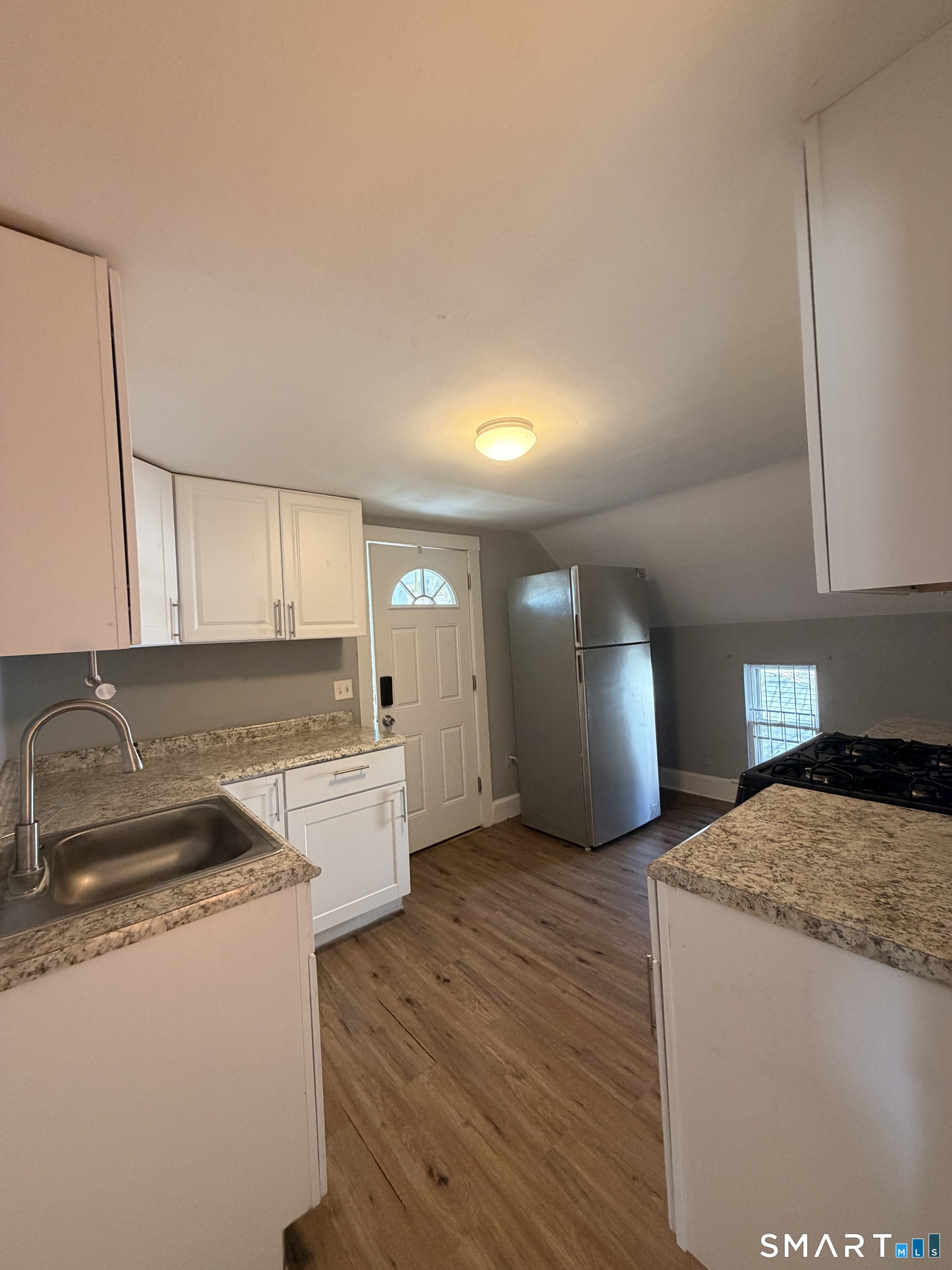 30 Sunset Avenue Waterbury, CT 06708 - Photo 3 of 9 a kitchen with a sink cabinets and wooden floor