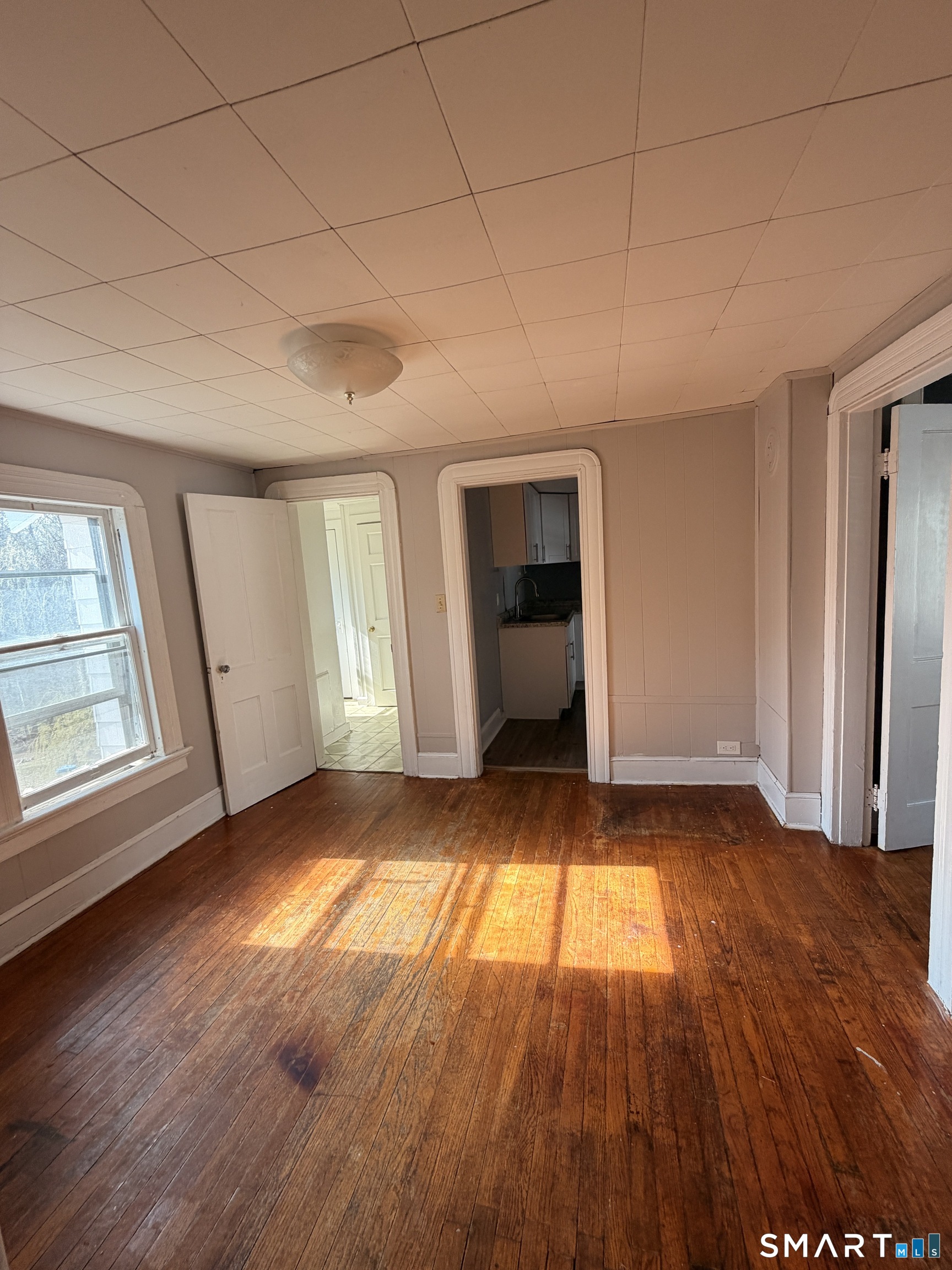 30 Sunset Avenue Waterbury, CT 06708 - Photo 4 of 9 an empty room with wooden floor and windows