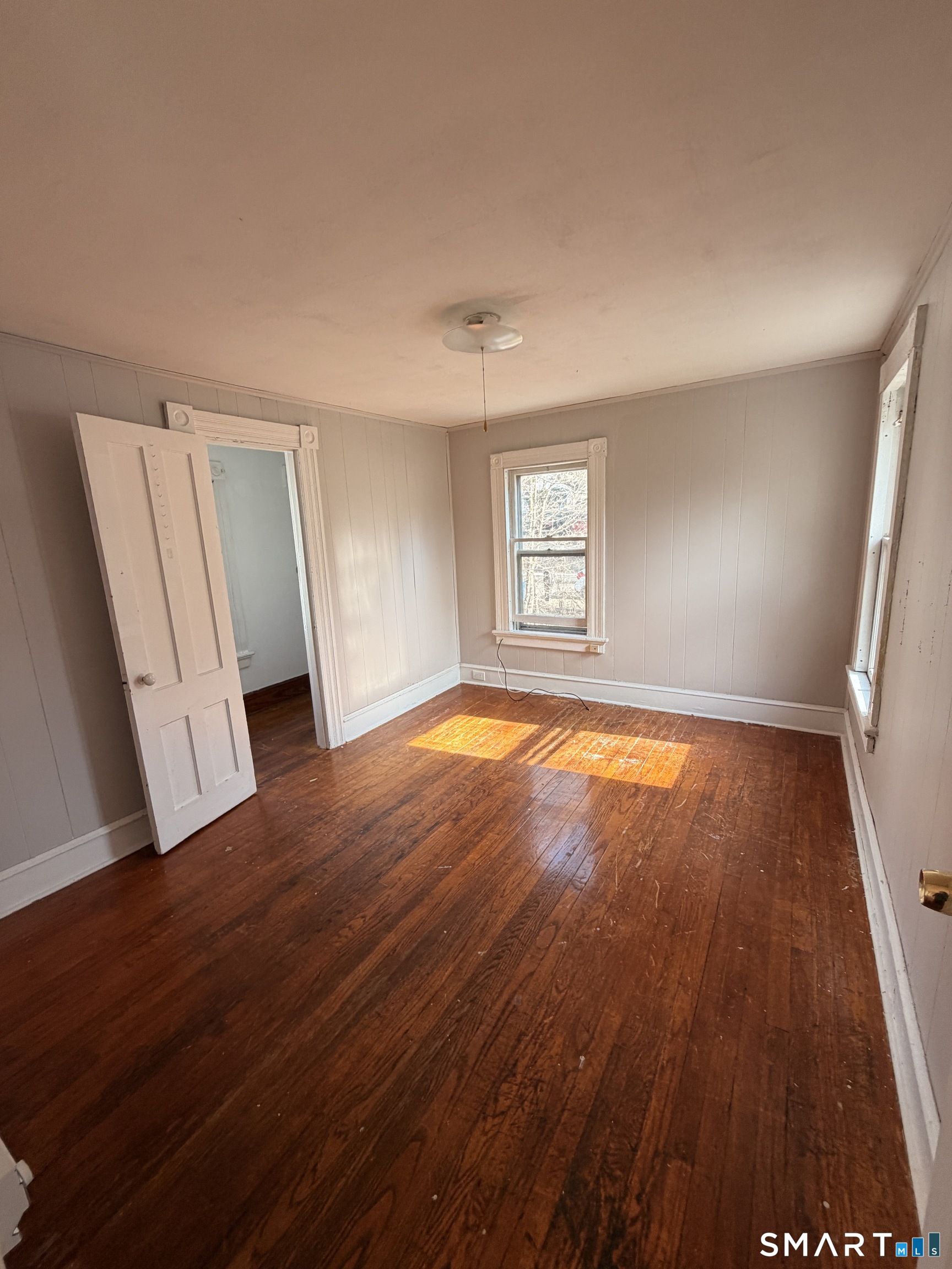 30 Sunset Avenue Waterbury, CT 06708 - Photo 5 of 9 an empty room with wooden floor and windows