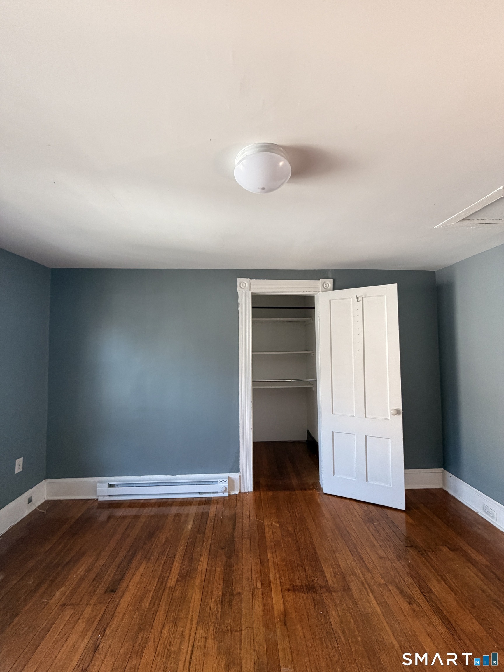 30 Sunset Avenue Waterbury, CT 06708 - Photo 8 of 9 a view of empty room with wooden floor and fan
