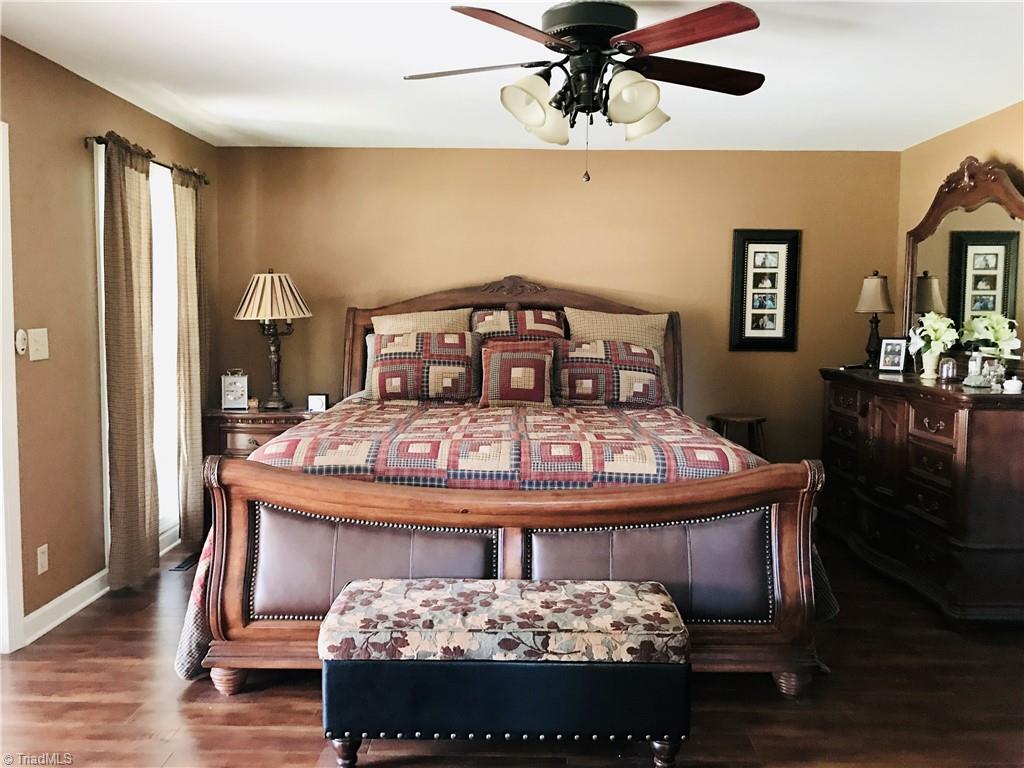 310 Cornatzer Road Mocksville, NC 27028 - Photo 25 of 46 The primary bedroom is beyond the kitchen, with plenty of space for king-sized furniture.