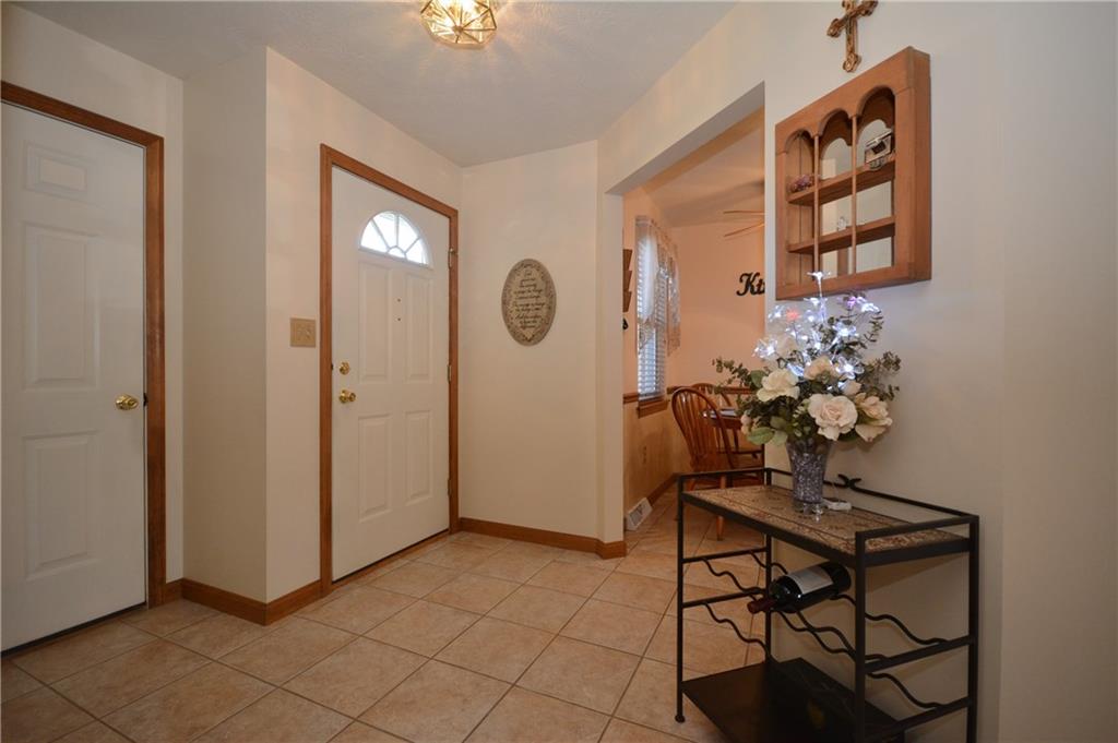 The entry way leads you into the breakfast nook with beautiful neutral ceramic tile.