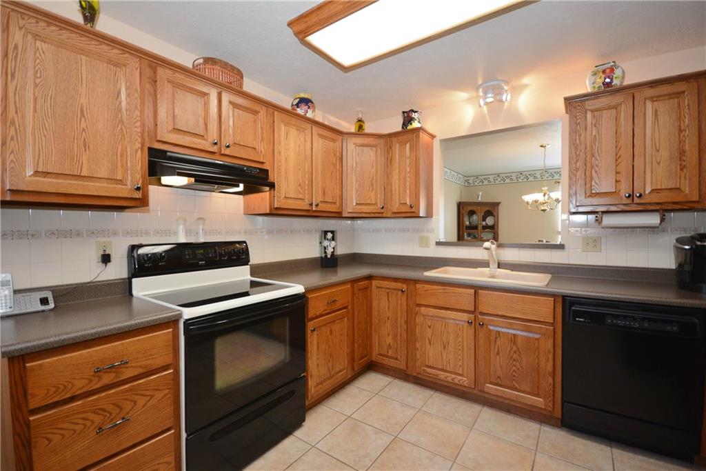 The kitchen has a very neutral look. Nice white back splash and ample counter top.