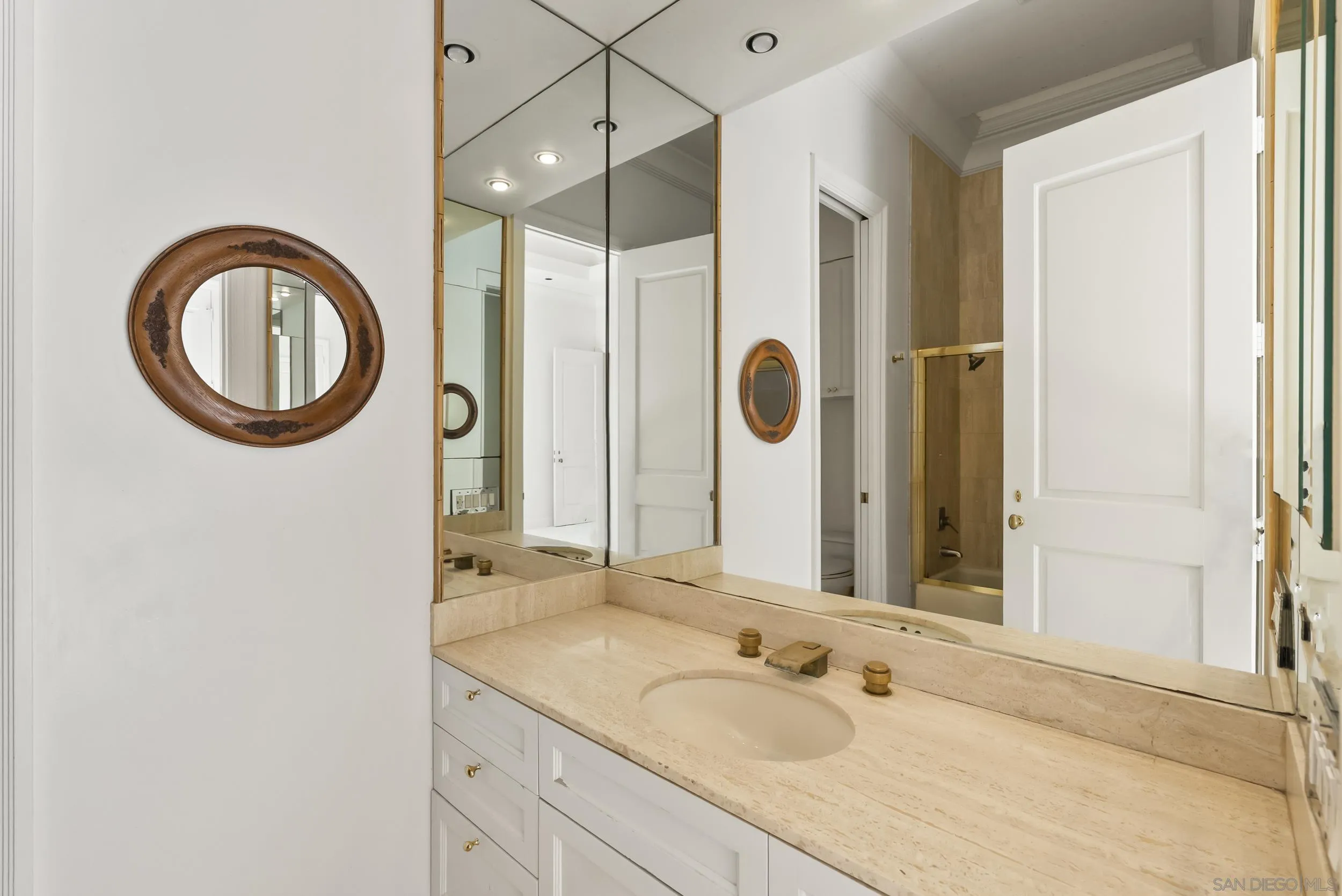 2302 Rue Adriane La Jolla, CA 92037 - Photo 21 of 31 a bathroom with a granite countertop sink and a mirror