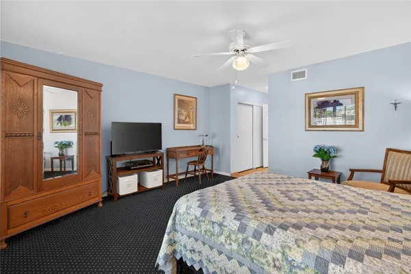a bedroom with bed and a chandelier