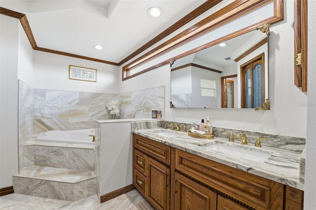 6128 Oak Ridge Avenue New Port Richey, FL 34653 - Photo 17 of 55 a bathroom with a sink and a mirror