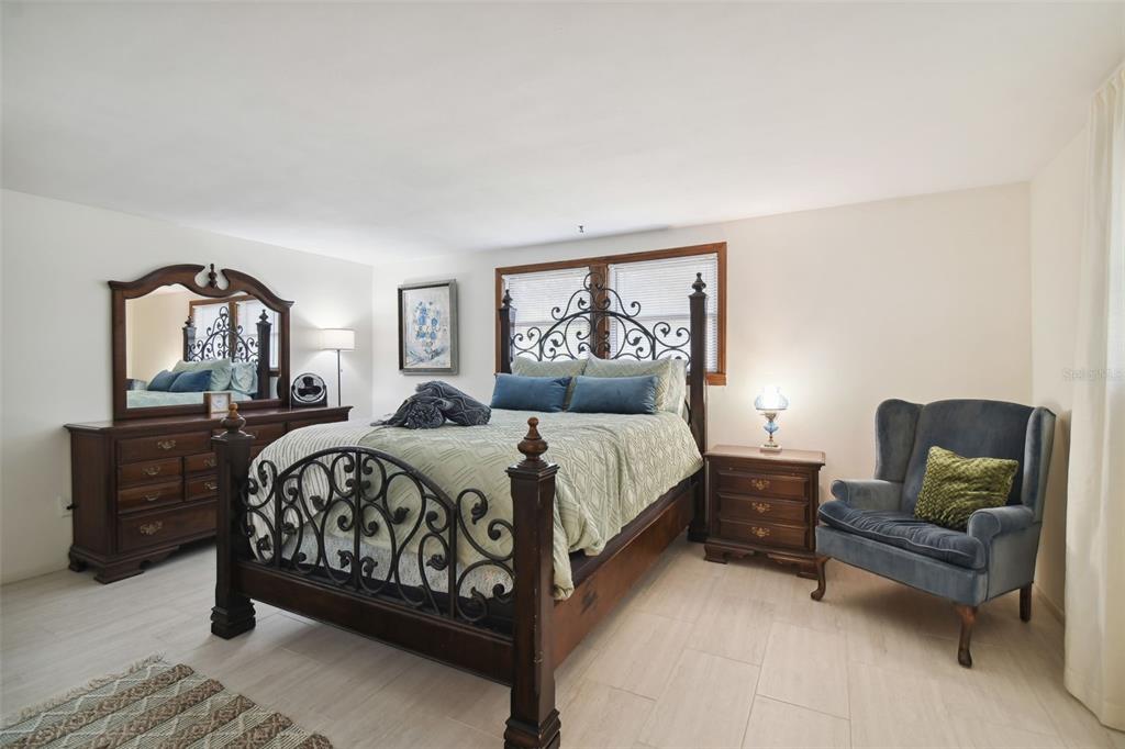 6128 Oak Ridge Avenue New Port Richey, FL 34653 - Photo 22 of 55 a bedroom with a bed mirror and window