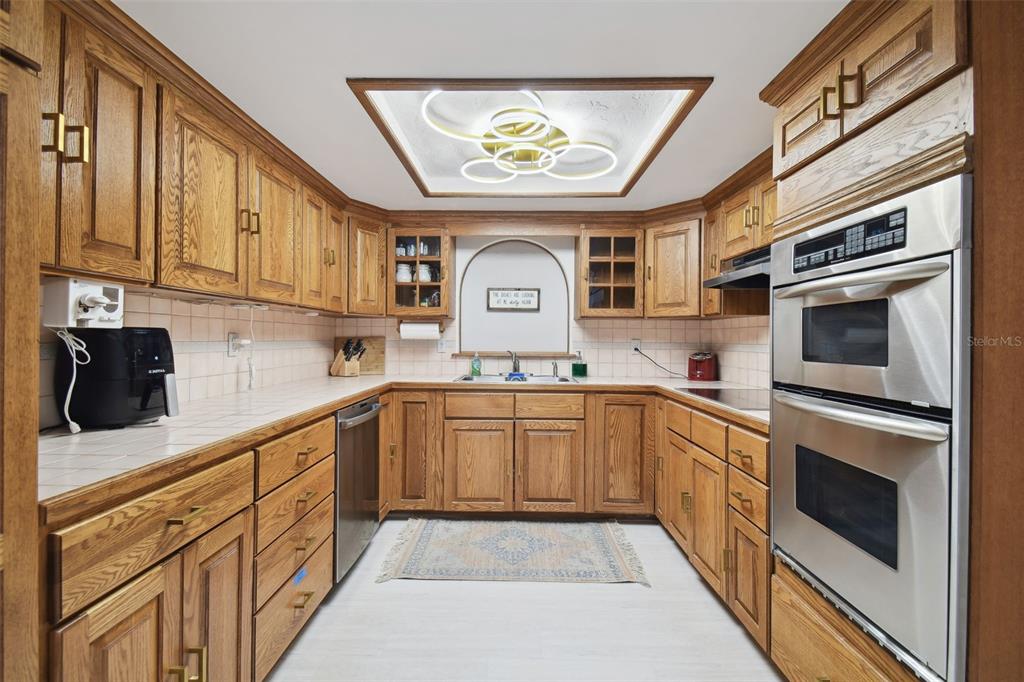 6128 Oak Ridge Avenue New Port Richey, FL 34653 - Photo 25 of 55 a kitchen with stainless steel appliances granite countertop a sink and cabinets