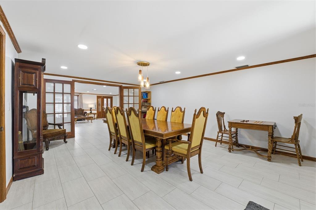 6128 Oak Ridge Avenue New Port Richey, FL 34653 - Photo 26 of 55 a dining room with furniture and a floor to ceiling window