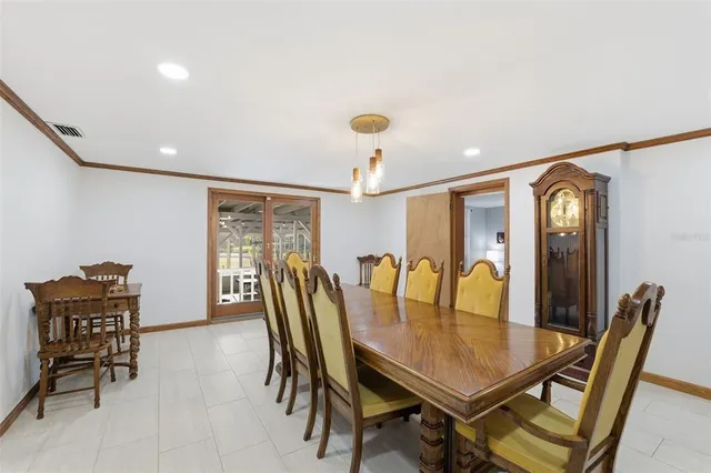 a dining room with furniture a chandelier and a rug