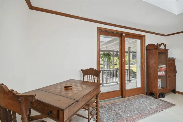 a view of a patio with table and chairs potted plants with wooden floor