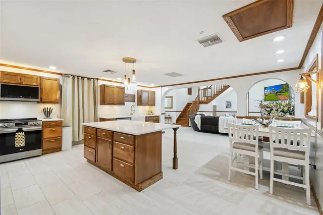 a view of a patio with table and chairs potted plants with floor to ceiling window