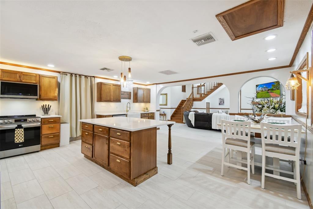 6128 Oak Ridge Avenue New Port Richey, FL 34653 - Photo 3 of 55 a kitchen with stainless steel appliances granite countertop a stove oven and a refrigerator with white cabinets
