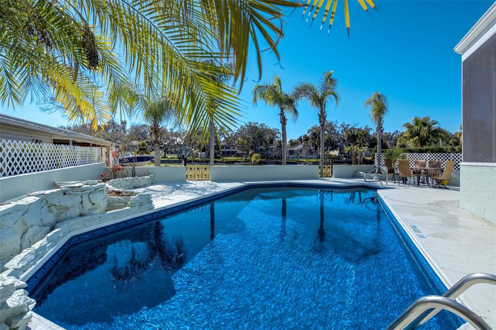 6128 Oak Ridge Avenue New Port Richey, FL 34653 - Photo 34 of 55 a swimming pool with outdoor seating and yard