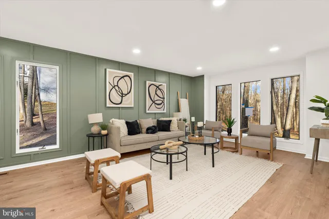 a large white kitchen with cabinets a sink and appliances