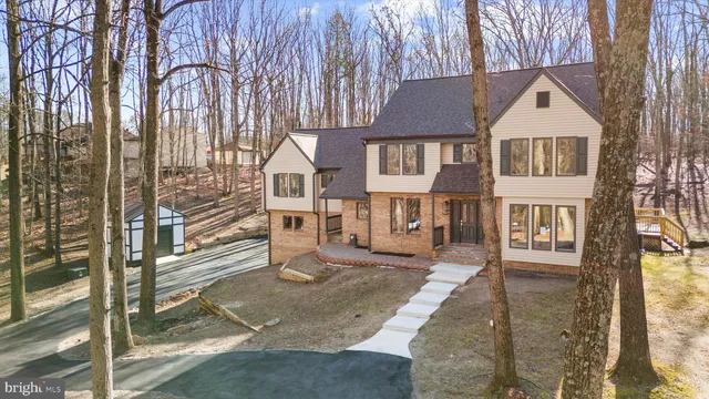a view of a house with a yard covered in snow
