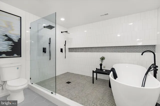 a bathroom with a bathtub and a shower