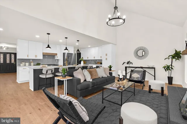 a living room with furniture and large windows