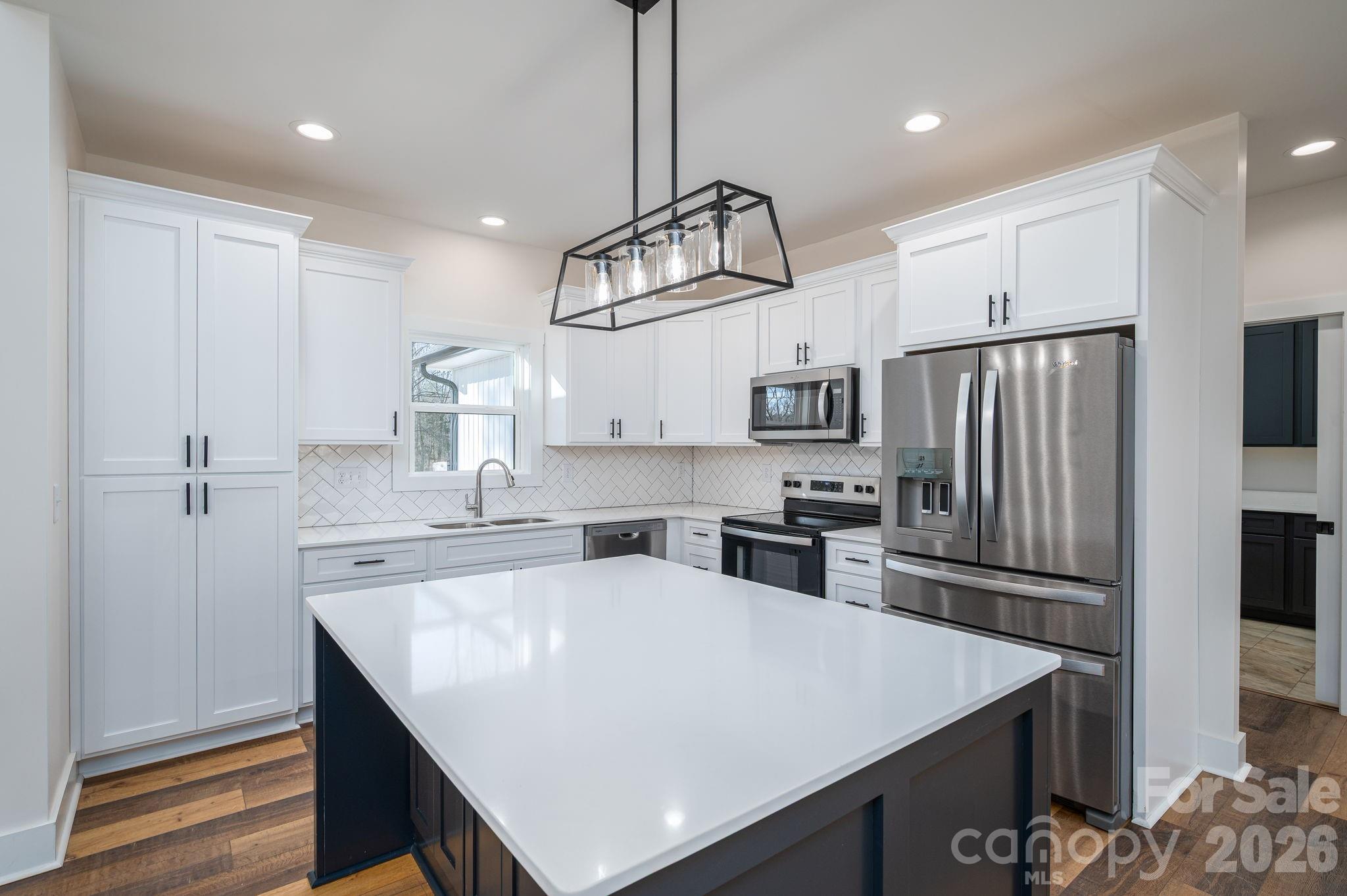 6335 Forney Hill Road Denver, NC 28037 - Photo 14 of 46 a kitchen with refrigerator cabinets and wooden floor