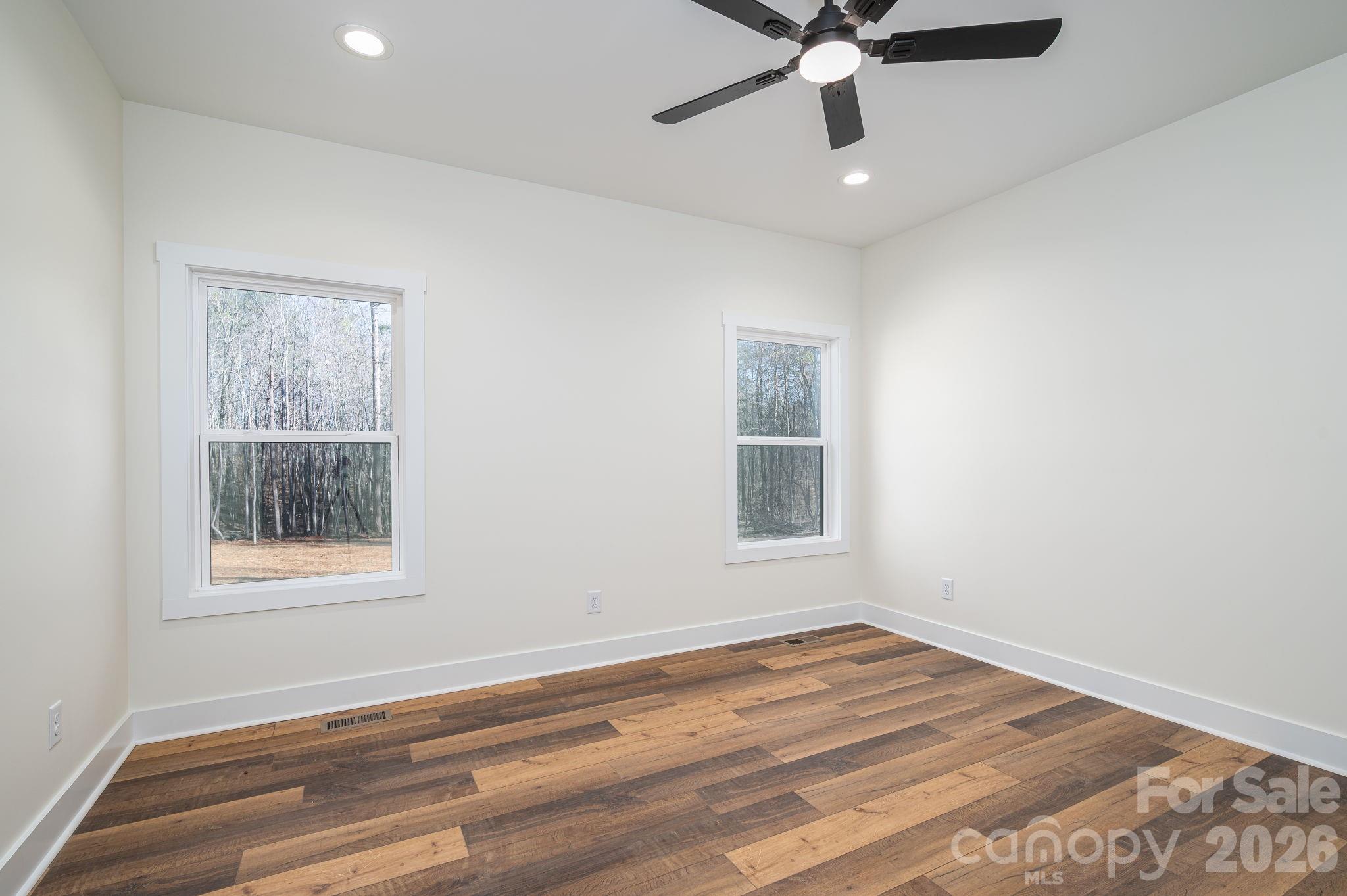 6335 Forney Hill Road Denver, NC 28037 - Photo 17 of 46 a view of an empty room with wooden floor and a window