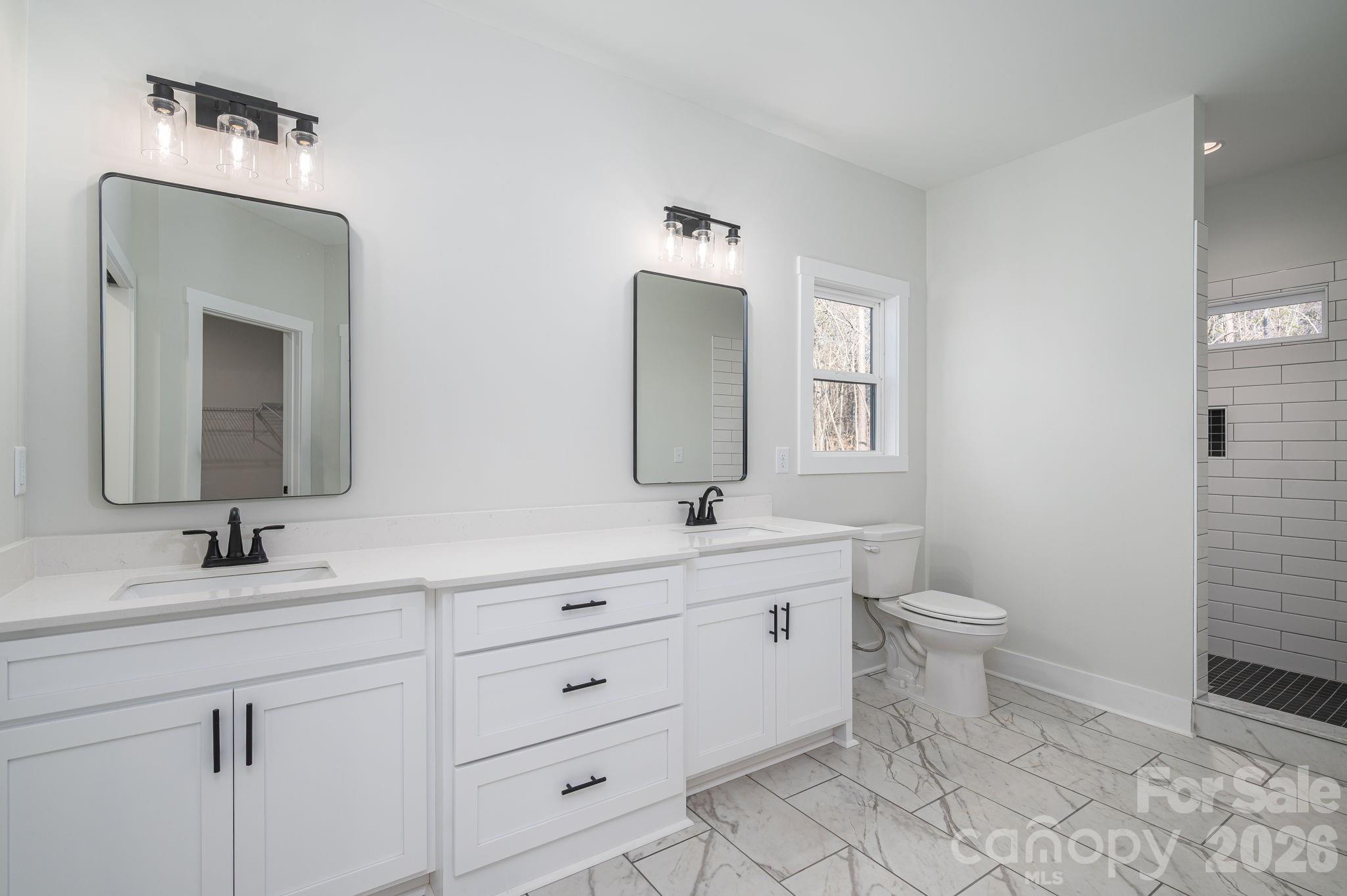 6335 Forney Hill Road Denver, NC 28037 - Photo 19 of 46 a bathroom with a toilet sink and mirror