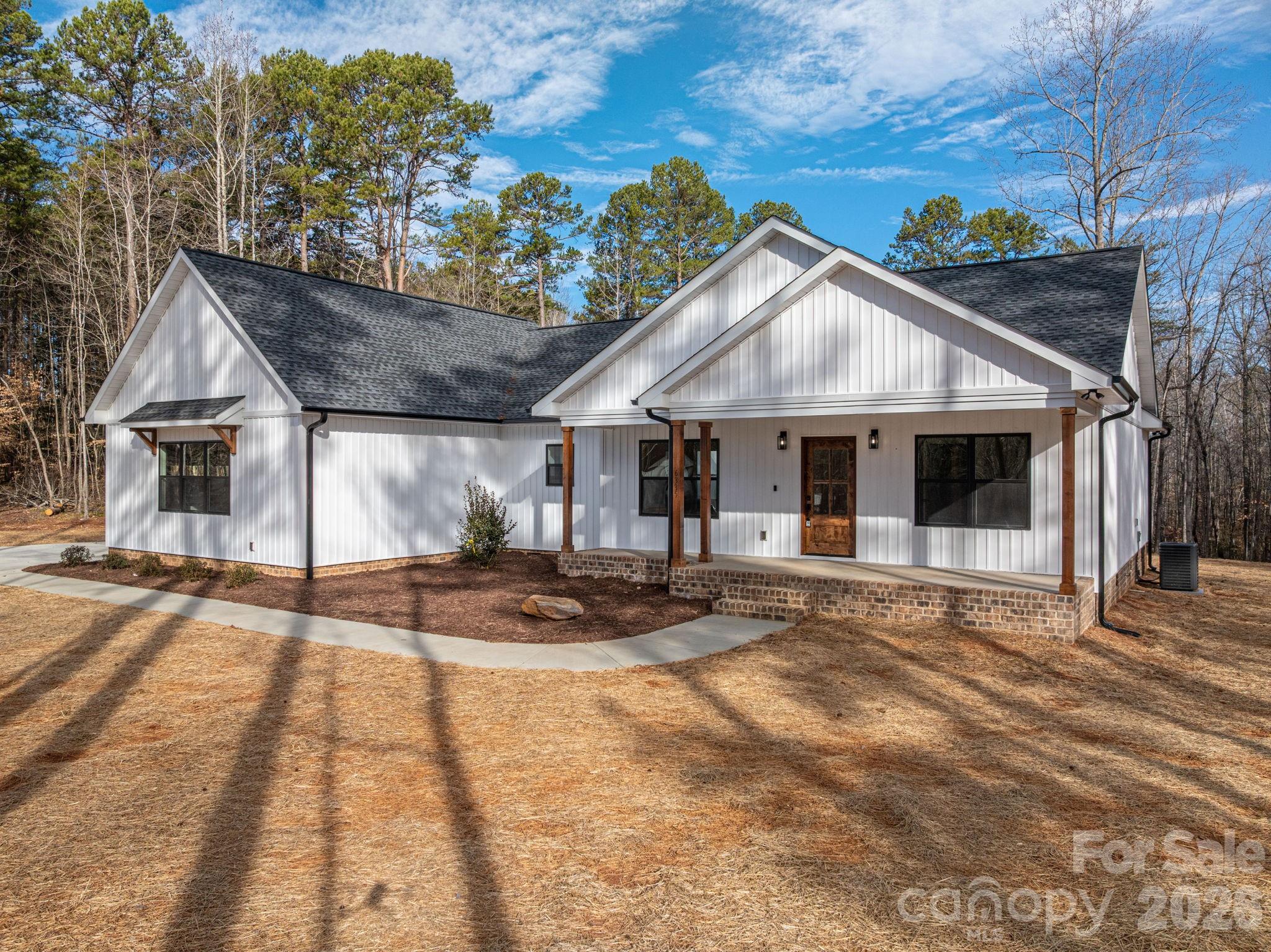 6335 Forney Hill Road Denver, NC 28037 - Photo 2 of 46 a front view of a house with garden