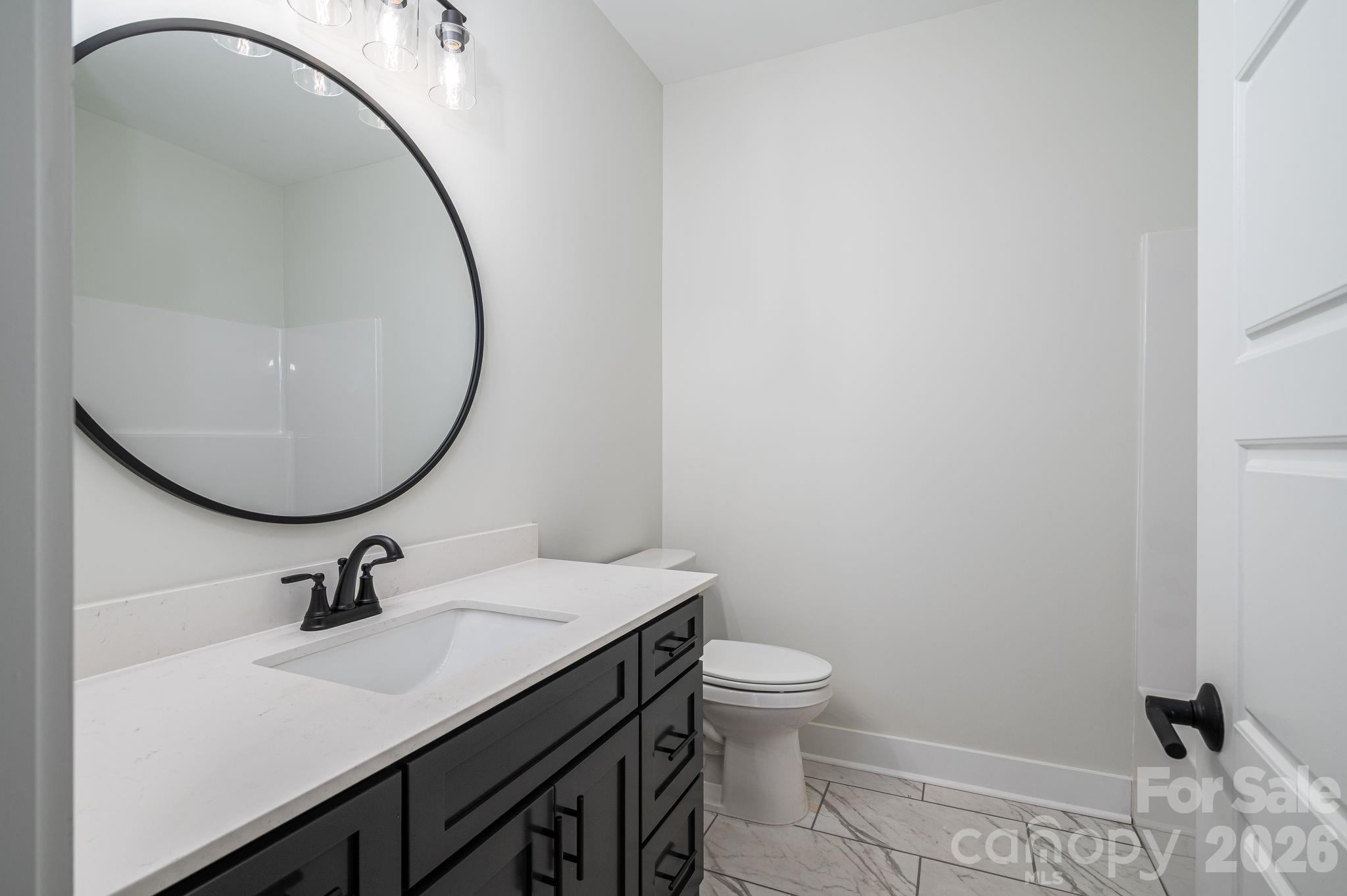 6335 Forney Hill Road Denver, NC 28037 - Photo 25 of 46 a bathroom with a sink a toilet and a mirror