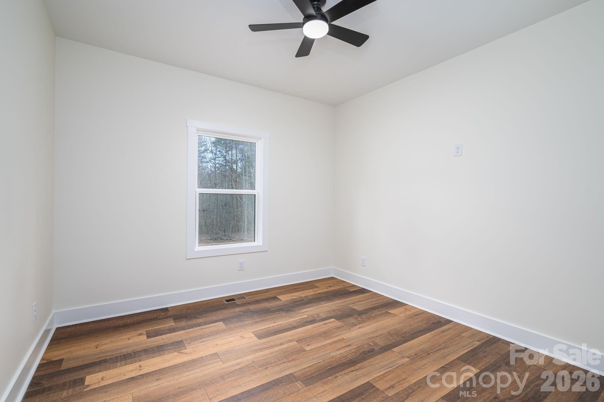 6335 Forney Hill Road Denver, NC 28037 - Photo 26 of 46 wooden floor in an empty room with a window
