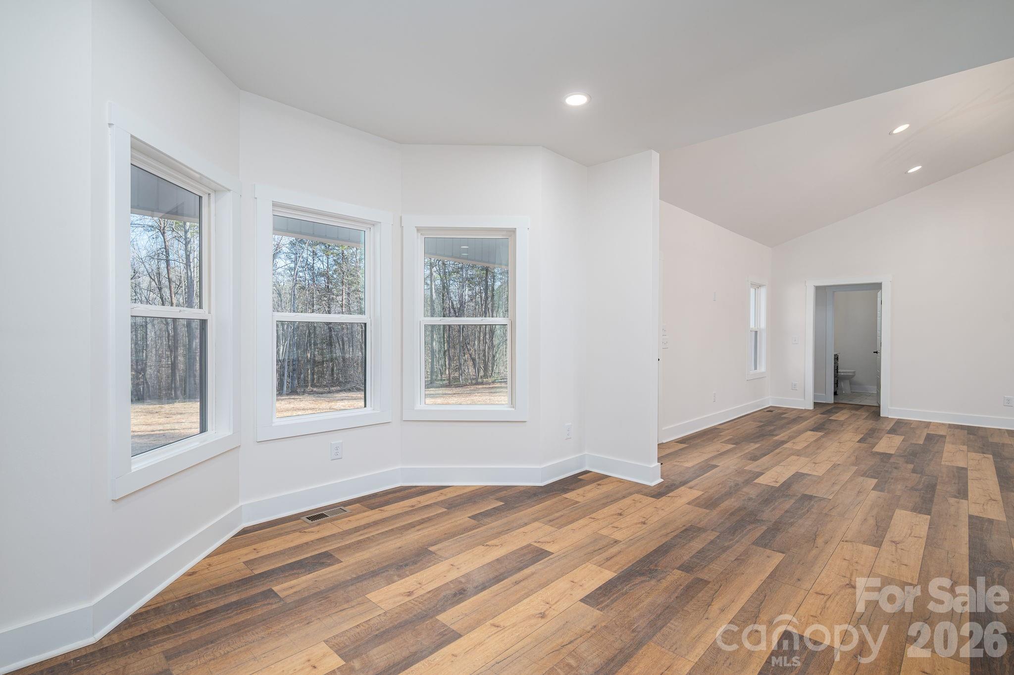 6335 Forney Hill Road Denver, NC 28037 - Photo 32 of 46 a view of empty room with wooden floor and fan