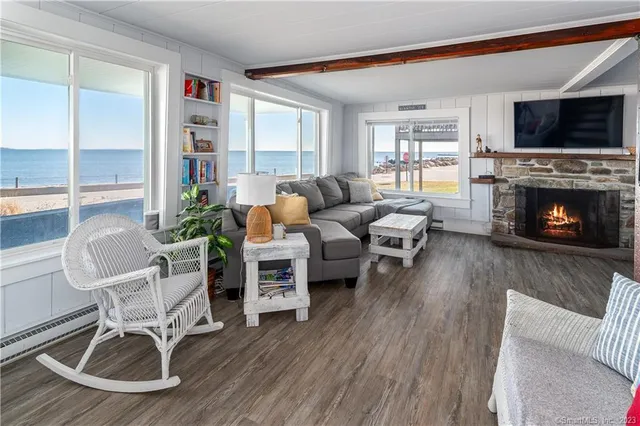 a living room with furniture a fireplace and a flat screen tv