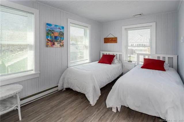 a bedroom with two beds and a window