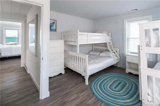 a bedroom with bed and a wooden floor