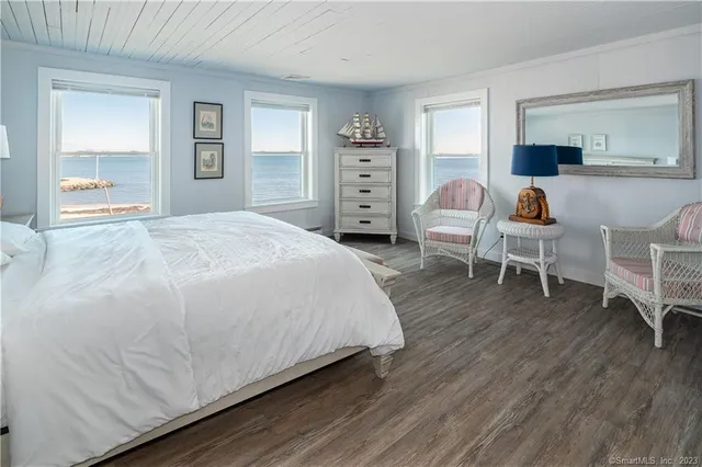 a spacious bedroom with a bed and a cabinets