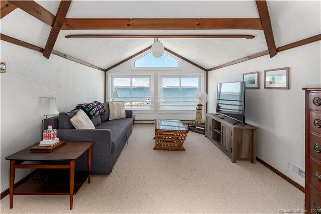 a bedroom with furniture and a flat screen tv