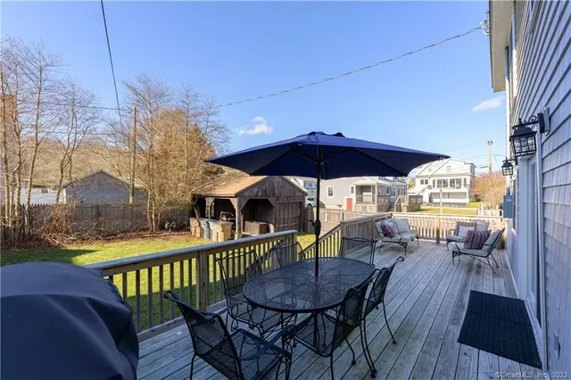 a view of a large house with a big yard and large trees