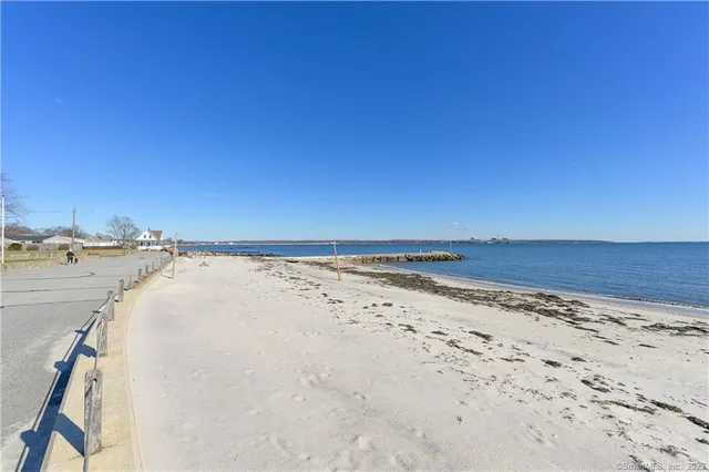 a view of a swimming pool and lounge chairs on the lake
