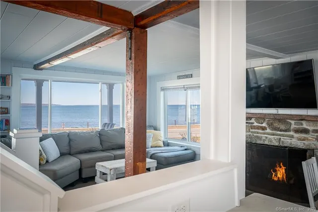 a living room with furniture a flat screen tv and a fireplace