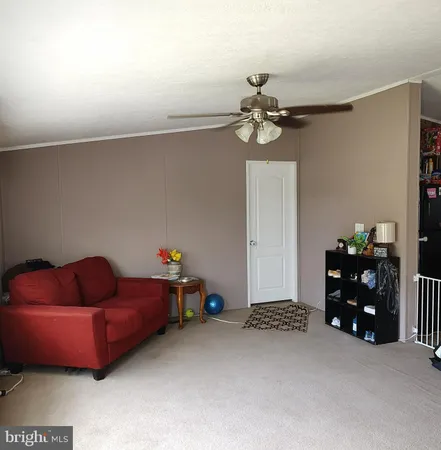 a bedroom with furniture and a fan