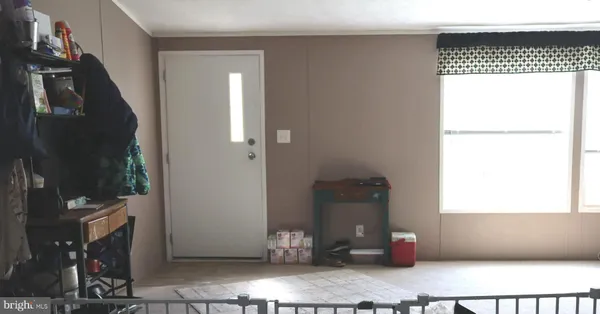 a view of two room with wooden floor