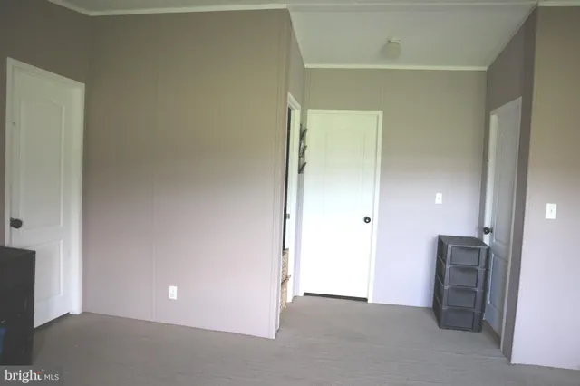 a view of an empty room with a bathroom