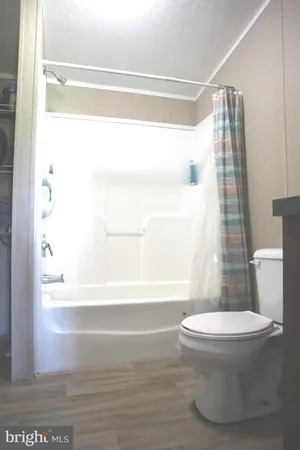 a bathroom with a sink toilet and mirror
