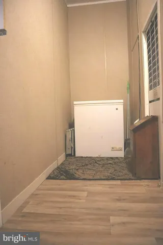 a view of an entryway with a small kitchen