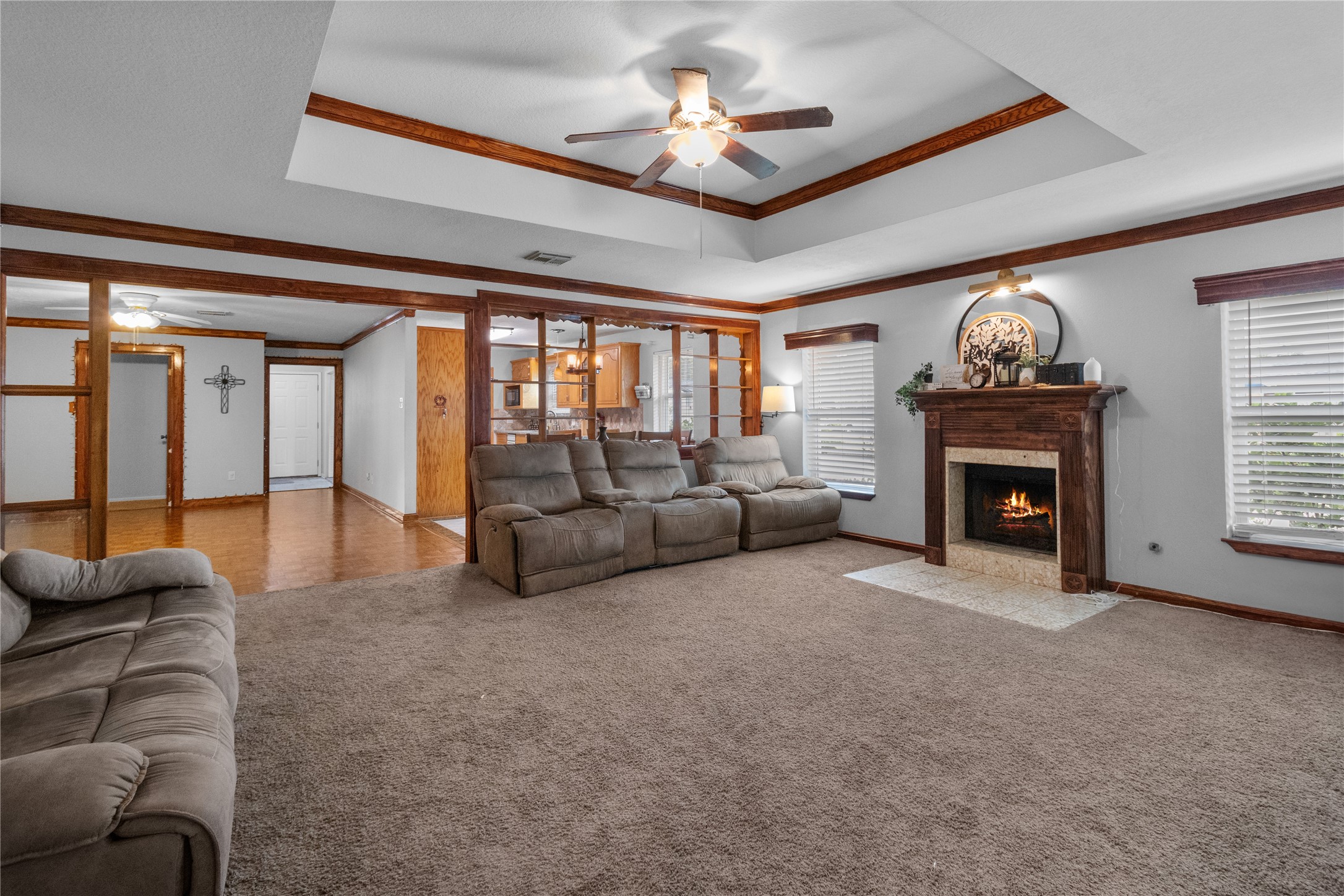 4322 Aztec Street Pasadena, TX 77504 - Photo 3 of 17 Gather in the heart of the home! The oversized living room features a charming fireplace, recessed ceiling, and plenty of space for movie nights, game days, or quiet evenings by the fire.